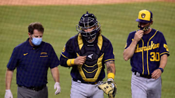 LOS ANGELES, CALIFORNIA - OCTOBER 01: Jacob Nottingham #26 of the Milwaukee Brewers is accompanied by Manager Craig Counsell #30 and medical staff as he leaves the game after injury during the sixth inning in game two of the National League Wild Card Series at Dodger Stadium on October 01, 2020 in Los Angeles, California. (Photo by Harry How/Getty Images)