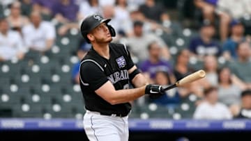 DENVER, CO - JUNE 17: C.J. Cron #25 of the Colorado Rockies follows the flight of a first inning grand slam homerun against the Milwaukee Brewers at Coors Field on June 17, 2021 in Denver, Colorado. (Photo by Dustin Bradford/Getty Images)