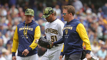 MILWAUKEE, WISCONSIN - MAY 22: Manager Craig Counsell #30 of the Milwaukee Brewers walks with Freddy Peralta #51 as he leaves the game during the fourth inning against the Washington Nationals at American Family Field on May 22, 2022 in Milwaukee, Wisconsin. (Photo by Stacy Revere/Getty Images)