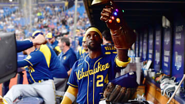 ST PETERSBURG, FLORIDA - JUNE 28: Andrew McCutchen #24 of the Milwaukee Brewers rings a bell while wearing a Thanos Guantlet after hitting a two-run home run in the sixth inning against the Tampa Bay Rays at Tropicana Field on June 28, 2022 in St Petersburg, Florida. (Photo by Julio Aguilar/Getty Images)