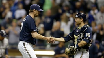 MILWAUKEE, WI - OCTOBER 1: John Axford #59 of the Milwaukee Brewers celebrates with Jonathan Lucroy #20 after the 5-3 win over the San Diego Padres at Miller Park on October 1, 2012 in Milwaukee, Wisconsin. (Photo by Mike McGinnis/Getty Images)