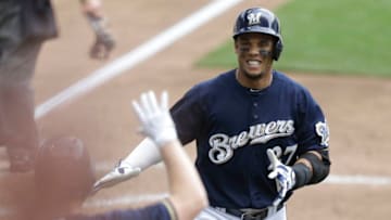MILWAUKEE, WI - JULY 08: Carlos Gomez #27 of the Milwaukee Brewers celebrates with Adam Lind #24 after hitting a solo home run in the sixth inning against the Atlanta Braves at Miller Park on July 08, 2015 in Milwaukee, Wisconsin. (Photo by Mike McGinnis/Getty Images)