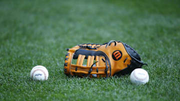 MILWAUKEE, WI - SEPTEMBER 03: A Wilson baseball glove and major league baseballs sits on the field at Miller Park on September 3, 2015 in Milwaukee, Wisconsin. (Photo by Jeff Haynes/Getty Images)