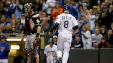 MILWAUKEE, WI - APRIL 21: Ryan Braun #8 of the Milwaukee Brewers scores a run past Bryan Holaday #28 of the Miami Marlins in the fourth inning at Miller Park on April 21, 2018 in Milwaukee, Wisconsin. (Photo by Dylan Buell/Getty Images)