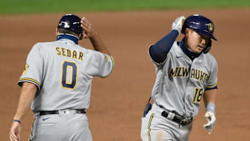 MINNEAPOLIS, MINNESOTA - AUGUST 19: Keston Hiura #18 of the Milwaukee Brewers celebrates with third base coach Ed Sedar #0 after hitting a solo home run as Hiura rounds the bases during the ninth inning of the game at Target Field on August 19, 2020 in Minneapolis, Minnesota. The Brewers defeated the Twins 9-3. (Photo by Hannah Foslien/Getty Images)