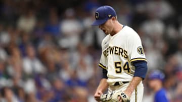 MILWAUKEE, WISCONSIN - JUNE 29: Jake Cousins #54 of the Milwaukee Brewers reacts after striking out Ian Happ #8 of the Chicago Cubs (not pictured) with the bases loaded in the seventh inning at American Family Field on June 29, 2021 in Milwaukee, Wisconsin. (Photo by Patrick McDermott/Getty Images)