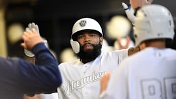 MILWAUKEE, WISCONSIN - AUGUST 23: Eric Thames #7 of the Milwaukee Brewers is congratulated by teammates following a solo home run against the Arizona Diamondbacks during the third inning at Miller Park on August 23, 2019 in Milwaukee, Wisconsin. Teams are wearing special color schemed uniforms with players choosing nicknames to display for Players Weekend. (Photo by Stacy Revere/Getty Images)