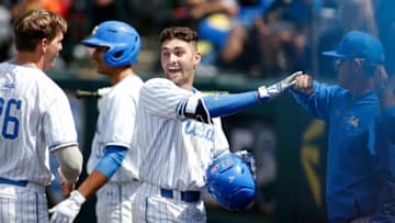 LOS ANGELES, CALIFORNIA - MAY 19: Garrett Mitchell #5 of UCLA fist-bumps a coach as he makes his way to the dugout following his home run during a baseball game against University of Washington at Jackie Robinson Stadium on May 19, 2019 in Los Angeles, California. (Photo by Katharine Lotze/Getty Images)