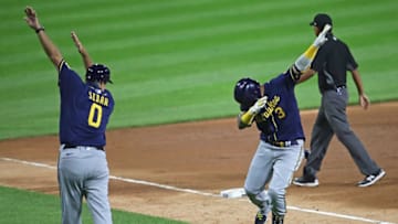 CHICAGO, ILLINOIS - JULY 22: Orlando Arcia #3 of the Milwaukee Brewers has a "social distance" celebration with third base coach Ed Sedar #0 after hitting a solo home run in the 9th inning against the Chicago White Sox during an exhibition game at Guaranteed Rate Field on July 22, 2020 in Chicago, Illinois. (Photo by Jonathan Daniel/Getty Images)