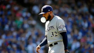 Aug 2, 2019; Chicago, IL, USA; Milwaukee Brewers relief pitcher Jeremy Jeffress (32) blows a bubble as he walks off the field after being taken out of the game against the Chicago Cubs during the sixth inning at Wrigley Field. Mandatory Credit: Jon Durr-USA TODAY Sports