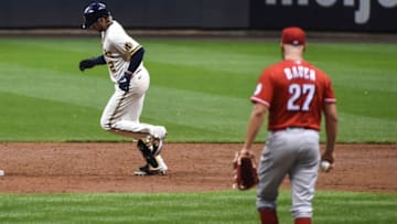 Aug 24, 2020; Milwaukee, Wisconsin, USA; Milwaukee Brewers first baseman Justin Smoak (12) runs the bases after hitting a 2-run homer against Cincinnati Reds pitcher Trevor Bauer (27) in the third inning at Miller Park. Mandatory Credit: Benny Sieu-USA TODAY Sports