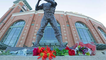 Flowers and mementos are laid at a makeshift memorial in front of the Henry Aaron statue at American Family Field Saturday, Jan. 23, 2021 in Milwaukee. Aaron, who began and ended his big-league career in Milwaukee and was known as "Hammerin' Hank" for his successful pursuit of Babe Ruth's cherished home run record, died early Jan. 22, 2021 in his sleep at age 86.Aaron Statue 06338