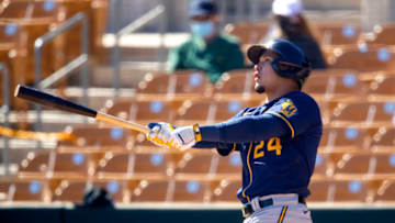 Feb 28, 2021; Glendale, Arizona, USA; Milwaukee Brewers outfielder Avisail Garcia hits a home run against the Chicago White Sox during a Spring Training game at Camelback Ranch Glendale. Mandatory Credit: Mark J. Rebilas-USA TODAY Sports