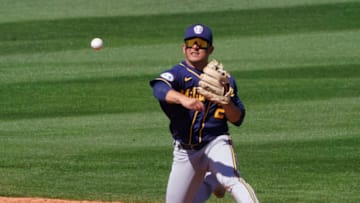 Mar 18, 2021; Tempe, Arizona, USA; Milwaukee Brewers third baseman Luis Urias (2) makes the play from his knees against the Los Angeles Angels during a spring training game at Tempe Diablo Stadium. Mandatory Credit: Rick Scuteri-USA TODAY Sports