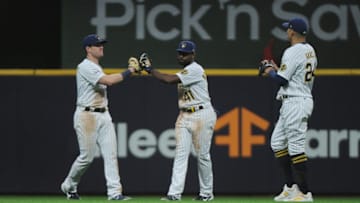 Apr 17, 2021; Milwaukee, Wisconsin, USA; Milwaukee Brewers left fielder Billy McKinney (11) and center fielder Jackie Bradley Jr. (41) and right fielder Avisail Garcia (24) congratulate each other after a 7-1 win over the Pittsburgh Pirates at American Family Field. Mandatory Credit: Michael McLoone-USA TODAY Sports