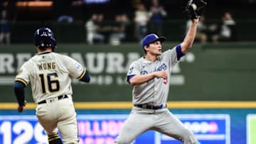 Apr 29, 2021; Milwaukee, Wisconsin, USA; Los Angeles Dodgers shortstop Corey Seager (5) forces out Milwaukee Brewers second baseman Kolten Wong (16) in the sixth inning at American Family Field. Mandatory Credit: Benny Sieu-USA TODAY Sports