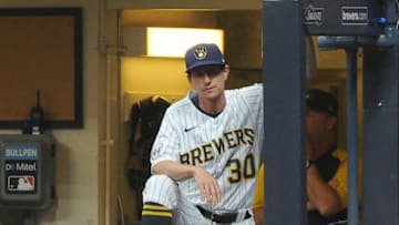 Jul 25, 2021; Milwaukee, Wisconsin, USA; Milwaukee Brewers manager Craig Counsell (30) looks on as Milwaukee Brewers center fielder Jackie Bradley Jr. (41) is up to bat against the Chicago White Sox in the seventh inning at American Family Field. Mandatory Credit: Michael McLoone-USA TODAY Sports