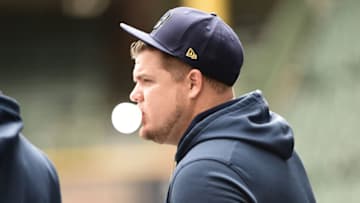 Oct 8, 2021; Milwaukee, Wisconsin, USA; Milwaukee Brewers first baseman Daniel Vogelbach (20) blows a bubble before game one of the 2021 NLDS against the Atlanta Braves at American Family Field. Mandatory Credit: Benny Sieu-USA TODAY Sports