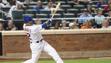 Jul 26, 2016; New York City, NY, USA; New York Mets center fielder Juan Lagares (12) reaches on an infield single to the shortstop during the fifth inning against the St. Louis Cardinals at Citi Field. Mandatory Credit: Anthony Gruppuso-USA TODAY Sports