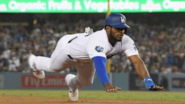 LOS ANGELES, CA - OCTOBER 27: Yasiel Puig #66 of the Los Angeles Dodgers dives safely into third base on a single by Chris Taylor #3 (not in photo) in the eighth inning of Game Four of the 2018 World Series against the Boston Red Sox at Dodger Stadium on October 27, 2018 in Los Angeles, California. (Photo by Harry How/Getty Images)