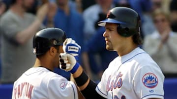 New York Mets catcher Mike Piazza (R) is congratulated by Jay Payton after Piazza hit his second home run of the game in the seventh inning against the Atlanta Braves, 09 April, 2001 at Shea Stadium in Flushing, NY. Piazza had two home runs and five RBI's as the Mets beat the braves 9-3 in their home opener. AFP PHOTO/Matt CAMPBELL (Photo by MATT CAMPBELL / AFP) (Photo by MATT CAMPBELL/AFP via Getty Images)