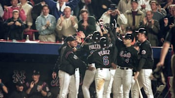 25 Oct 2000: Mike Piazza #31 of the New York Mets celebrates in the dugout after hitting a home run during Game 4 of the 2000 World Series against the New York Yankees at Shea Stadium in New York, New York. The Yankees defeated the Mets 3-2.Mandatory Credit: Al Bello /Allsport