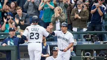 SEATTLE, WA - SEPTEMBER 23: Nelson Cruz #23 of the Seattle Mariners is greeted at the dugout after scoring on a double by Kyle Seager #15 in the sixth inning at Safeco Field on September 23, 2017 in Seattle, Washington. (Photo by Lindsey Wasson/Getty Images)