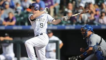 Sep 27, 2015; Denver, CO, USA; Colorado Rockies second baseman DJ LeMahieu (9) hits an RBI single during the fourth inning against the Los Angeles Dodgers at Coors Field. The Rockies won 12-5. Mandatory Credit: Chris Humphreys-USA TODAY Sports