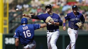 Mar 26, 2016; Salt River Pima-Maricopa, AZ, USA; Colorado Rockies second baseman DJ LeMahieu (9) turns the double play while avoiding Texas Rangers left fielder Ryan Rua (16) in the fourth nning during a spring training game at Salt River Fields at Talking Stick. Mandatory Credit: Rick Scuteri-USA TODAY Sports