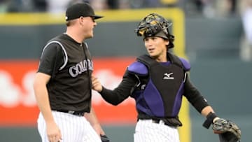 Apr 10, 2016; Denver, CO, USA; Colorado Rockies relief pitcher Jake McGee (51) and catcher Tony Wolters (14) celebrate the win over the San Diego Padres at Coors Field. The Rockies defeated the Padres 6-3. Mandatory Credit: Ron Chenoy-USA TODAY Sports