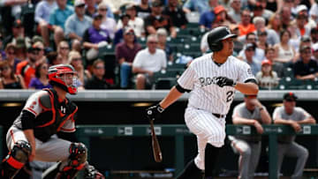 Apr 14, 2016; Denver, CO, USA; Colorado Rockies starting pitcher Jorge De La Rosa (29) hits a two RBI single in the fifth inning against the San Francisco Giants at Coors Field. Mandatory Credit: Isaiah J. Downing-USA TODAY Sports