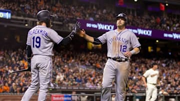 May 5, 2016; San Francisco, CA, USA; Colorado Rockies first baseman Mark Reynolds (12) celebrates with center fielder Charlie Blackmon (19) after scoring against the San Francisco Giants in the fifth inning at AT&T Park. Mandatory Credit: John Hefti-USA TODAY Sports