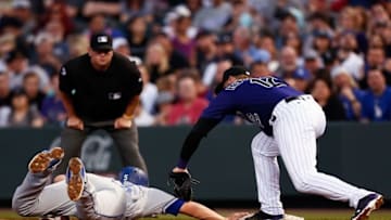 Apr 22, 2016; Denver, CO, USA; Los Angeles Dodgers shortstop Corey Seager (5) dives back to first base against Colorado Rockies first baseman Mark Reynolds (12) in the third inning at Coors Field. Mandatory Credit: Isaiah J. Downing-USA TODAY Sports