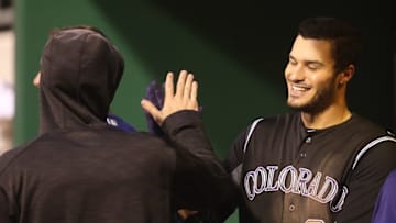 May 20, 2016; Pittsburgh, PA, USA; Colorado Rockies third baseman Nolan Arenado (28) high-fives in the dugout after hitting a solo home against the Pittsburgh Pirates during the sixth inning at PNC Park. Mandatory Credit: Charles LeClaire-USA TODAY Sports