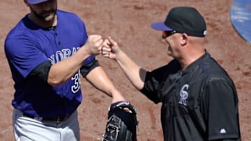 May 4, 2016; San Diego, CA, USA; Colorado Rockies starting pitcher Tyler Chatwood (left) fist bumps pitching coach Steve Foster (56) after the eighth inning against the San Diego Padres at Petco Park. Mandatory Credit: Jake Roth-USA TODAY Sports