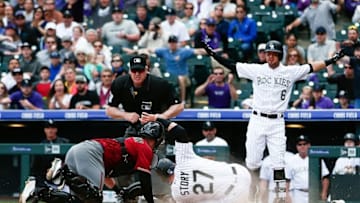 May 11, 2016; Denver, CO, USA; Colorado Rockies shortstop Trevor Story (27) slides safely into home against Arizona Diamondbacks catcher Chris Herrmann (10) in the third inning at Coors Field. Mandatory Credit: Isaiah J. Downing-USA TODAY Sports