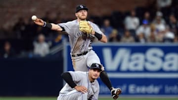 May 2, 2016; San Diego, CA, USA; Colorado Rockies shortstop Trevor Story (top) thows out San Diego Padres center fielder Jon Jay (not pictured) at first as third baseman Nolan Arenado (bottom) looks on during the second inning at Petco Park. Mandatory Credit: Jake Roth-USA TODAY Sports