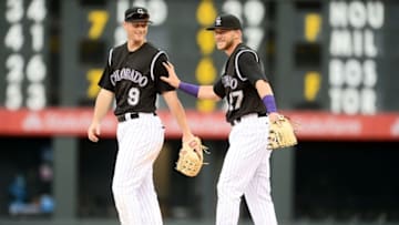 Apr 10, 2016; Denver, CO, USA; Colorado Rockies shortstop Trevor Story (27) and second baseman DJ LeMahieu (9) celebrate the win over the San Diego Padres at Coors Field. The Rockies defeated the Padres 6-3. Mandatory Credit: Ron Chenoy-USA TODAY Sports