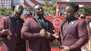 Jul 13, 2016; Los Angeles, CA, USA; WWE wrestlers of The New Day known as Kofi Nahaje Sarkodie-Mensah (left) and Ettore Ewen (center) and Austin Watson (right) arrive on the red carpet for the 2016 ESPY Awards at Microsoft Theater. Mandatory Credit: Kirby Lee-USA TODAY Sports