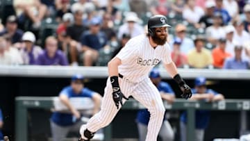Jun 29, 2016; Denver, CO, USA; Colorado Rockies center fielder Charlie Blackmon (19) attempts to run out a ground ball in the ninth inning against the Toronto Blue Jays at Coors Field. The Blue Jays defeated the Rockies 5-3. Mandatory Credit: Ron Chenoy-USA TODAY Sports