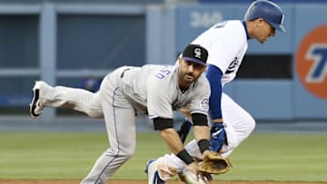 Jul 1, 2016; Los Angeles, CA, USA; Colorado Rockies second baseman Daniel Descalso (left) attempts to avoid Los Angeles Dodgers center fielder Trayce Thompson (right) after throwing to first to complete the double play during the third inning at Dodger Stadium. Mandatory Credit: Richard Mackson-USA TODAY Sports