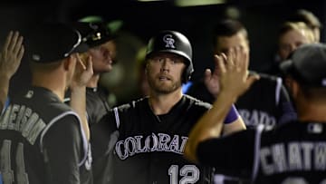 Jul 7, 2016; Denver, CO, USA; Colorado Rockies first baseman Mark Reynolds (12) celebrates scoring a run in the seventh inning against the Philadelphia Phillies at Coors Field. The Rockies defeated the Phillies 11-2. Mandatory Credit: Ron Chenoy-USA TODAY Sports