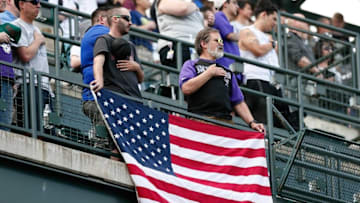 Apr 14, 2016; Denver, CO, USA; Colorado Rockies fans hold an American flag during the national anthem prior to the game against the San Francisco Giants at Coors Field. Mandatory Credit: Isaiah J. Downing-USA TODAY Sports