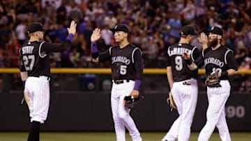 Jul 9, 2016; Denver, CO, USA; Colorado Rockies right fielder Carlos Gonzalez (5) and center fielder Charlie Blackmon (19) celebrate with second baseman DJ LeMahieu (9) and shortstop Trevor Story (27) following the game against the Philadelphia Phillies at Coors Field. The Rockies defeated the Phillies 8-3. Mandatory Credit: Isaiah J. Downing-USA TODAY Sports