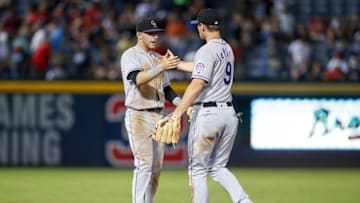 Jul 16, 2016; Atlanta, GA, USA; Colorado Rockies shortstop Trevor Story (27) and second baseman DJ LeMahieu (9) celebrate a victory against the Atlanta Braves at Turner Field. The Rockies defeated the Braves 4-3. Mandatory Credit: Brett Davis-USA TODAY Sports