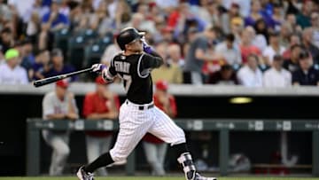 Jul 7, 2016; Denver, CO, USA; Colorado Rockies shortstop Trevor Story (27) hits a solo home run in the fifth inning against the Philadelphia Phillies at Coors Field. Mandatory Credit: Ron Chenoy-USA TODAY Sports