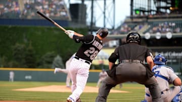 Aug 3, 2016; Denver, CO, USA; Colorado Rockies third baseman Nolan Arenado (28) hits a three run home run in the first inning against the Los Angeles Dodgers at Coors Field. Mandatory Credit: Ron Chenoy-USA TODAY Sports