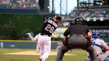 Aug 3, 2016; Denver, CO, USA; Colorado Rockies third baseman Nolan Arenado (28) hits a three run home run in the first inning against the Los Angeles Dodgers at Coors Field. Mandatory Credit: Ron Chenoy-USA TODAY Sports