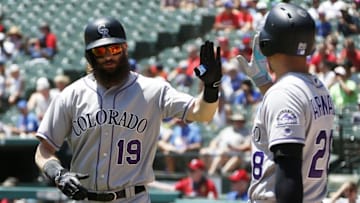 Aug 11, 2016; Arlington, TX, USA; Colorado Rockies center fielder Charlie Blackmon (19) is congratulated by third baseman Nolan Arenado (28) after hitting a home run in the first inning against the Texas Rangers at Globe Life Park in Arlington. Mandatory Credit: Tim Heitman-USA TODAY Sports