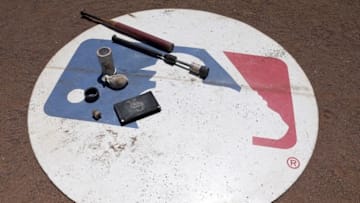 Aug 11, 2016; Arlington, TX, USA; A general view of the MLB logo with Colorado Rockies batting gear on it during the game against the Texas Rangers at Globe Life Park in Arlington. Colorado Rockies won 12-9. Mandatory Credit: Tim Heitman-USA TODAY Sports